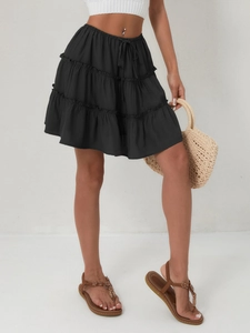Detail of high waisted black tiered mini skirt with adjustable drawstring and layered design