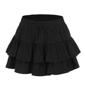 Detail view of black layered ruffle skirt with adjustable drawstring and polka dot texture