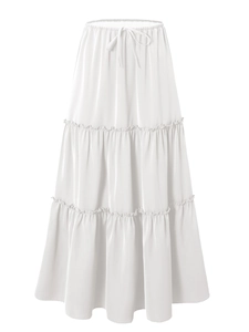 Detail of white tiered maxi skirt featuring elastic drawstring waist and layered ruffle design