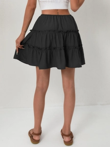 Rear view of black tiered ruffle mini skirt with high elastic waist and layered design