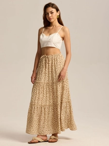 Detail of high waist maxi skirt with adjustable drawstring and tiered floral pattern