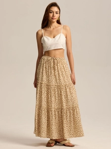 Detail of white cropped camisole and floral tiered maxi skirt with adjustable drawstring