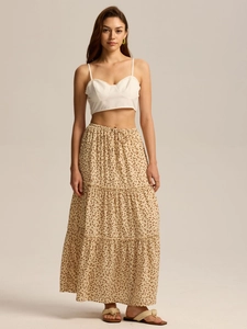 Detail view of high-waisted tiered maxi skirt with floral print and adjustable drawstring