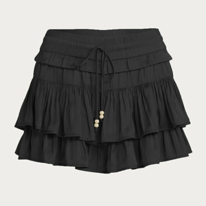 Detail of black tiered ruffle skort with elastic waistband and beaded drawstring