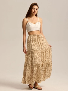 Detail of tiered floral maxi skirt with elastic high waist and white crop top set
