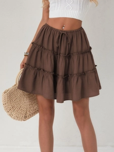 Detail view of brown tiered ruffle mini skirt with adjustable drawstring elastic waist