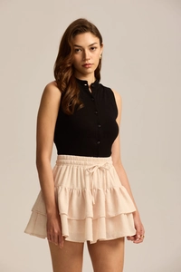 Detail of a pink layered chiffon mini skirt with adjustable drawstring elastic waist