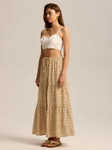 Detail of high waist tiered floral maxi skirt with elastic waistband and bow tie drawstring