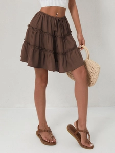 Detail of tiered brown mini skirt featuring adjustable drawstring and elastic waistband