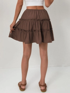 Detail view of the brown tiered mini skirt featuring elastic waist and layered ruffles