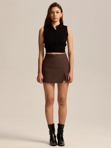 Detail view of high waist brown A-line skort paired with black sleeveless polo top