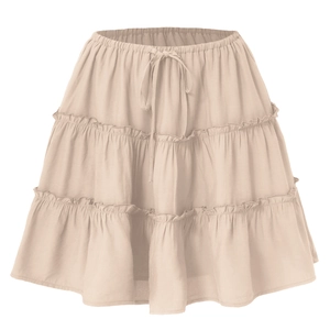 Detail of tiered beige mini skirt showing elastic waistband and adjustable drawstring