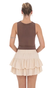 Back view of high waisted tiered mini skirt with elastic waist and ruffled detail