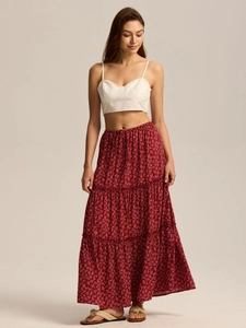 Close-up of bohemian red floral tiered maxi skirt with elastic high waist and white tank top