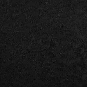Vue macro détaillée du tissu en dentelle florale noire avec des motifs de maille complexes
