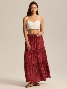 Detail of high waist tiered maxi skirt in burgundy floral print with elastic waistband
