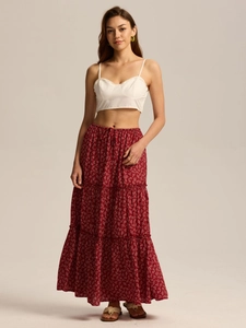 Detail of red floral tiered skirt with elastic drawstring waist and lightweight fabric