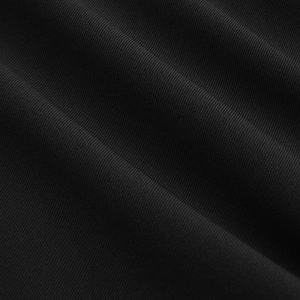 Macro detail of high-density black twill fabric showing fine texture and weave pattern
