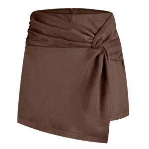 Detail of brown faux suede skort featuring a stylish front twist knot and pleated texture