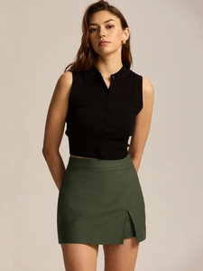 Detail of high-waist split skirt with side zipper and elegant front overlap design