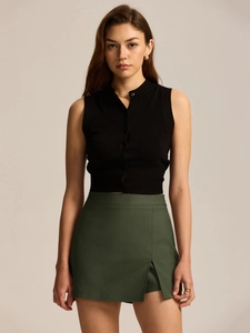 Detail view of the ribbed knit top buttons and side slit of the green skort outfit
