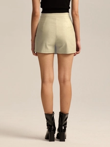 Rear view of high waist split skirt shorts in light beige with subtle metallic texture