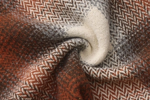 Macro shot of high-quality orange herringbone wool fabric for autumn skirts and capes