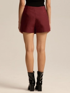 Rear view of burgundy high-waisted skort with clean lines and smooth woven fabric texture