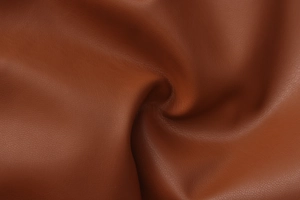 Detailed close-up of dark brown PU leather texture with irregular draping folds