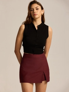 Detailed view of high-waist wine red mini skirt featuring elegant side split and premium fabric