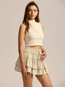 Detail of high-waist tiered skort with adjustable drawstring and wooden beads
