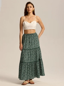 Detail of high waist floral maxi skirt with elastic waistband and tiered ruffle design