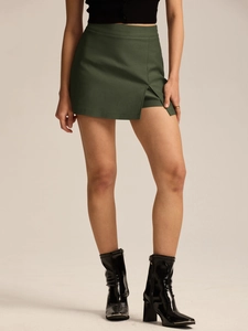 Detail view of high waist dark green skort with side slit and smooth woven fabric