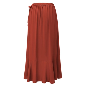 Detail view of ruffle hem and gathered elastic waist on rust red wrap midi skirt