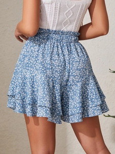 Back view of a blue floral tiered skort with elastic high waist and ruffle details