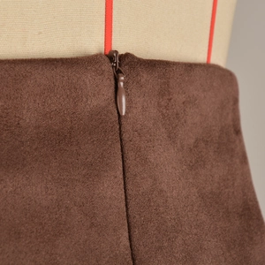Close-up of the invisible zipper and brown faux suede texture on this stylish skort