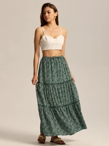 Full view of women's bohemian set with white crop top and floral green tiered maxi skirt