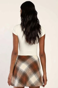 Back view of high waisted plaid A-line skirt paired with a white ribbed short sleeve top