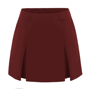 Detail of high waist burgundy pleated A-line skort with elegant front split design