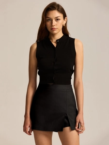 Detailed close-up showing the elastic suit fabric and stylish side slit of the black skirt