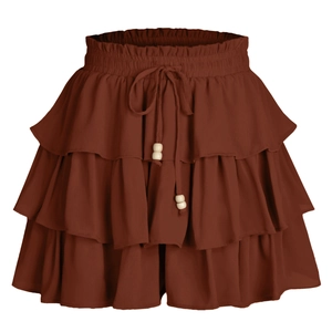 Detail view of tan tiered ruffle skort with elastic drawstring waist and wooden beads