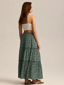 Detail of smocked crop top and tiered floral maxi skirt with elastic high waist