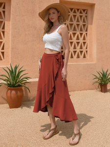 Detail of high waisted wrap skirt with side tie and ruffle trim for summer beach resort