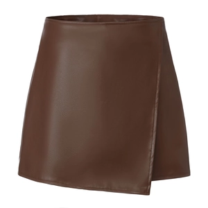 Detailed close-up of brown PU leather asymmetric wrap skort with high-waisted zipper design
