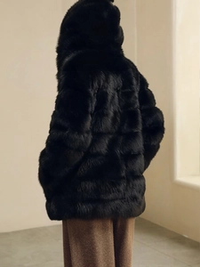 Chic black faux fox fur hooded coat for women with horizontal quilting and oversized fit