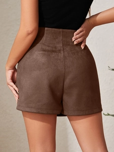 Back view of women's high-waisted brown suede skort with slim fit and center seam detail