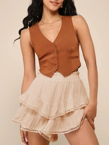 Detail of bohemian tiered mini skirt with delicate lace trim and elastic waist