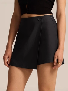 High-waisted asymmetrical black skort with button detail and side zipper for women
