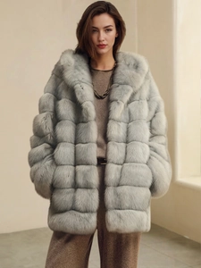 Close-up of light gray faux fox fur coat with quilted block texture and warm hood detail