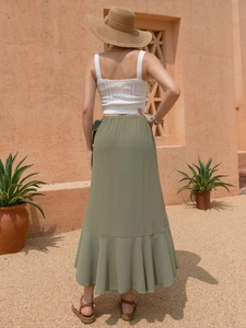 Outdoor back view of an olive green chiffon wrap skirt with ruffle hem and high waist